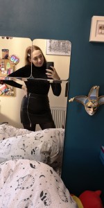 mirror pic of black studded backless body suit 